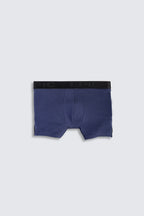 Navy blue boxer briefs with black waistband on a light gray background